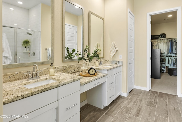 24757 N 175th Dr, Surprise, AZ 85387 - full bath with double vanity, a stall shower, a walk in closet, wood tiled floors, and recessed lighting