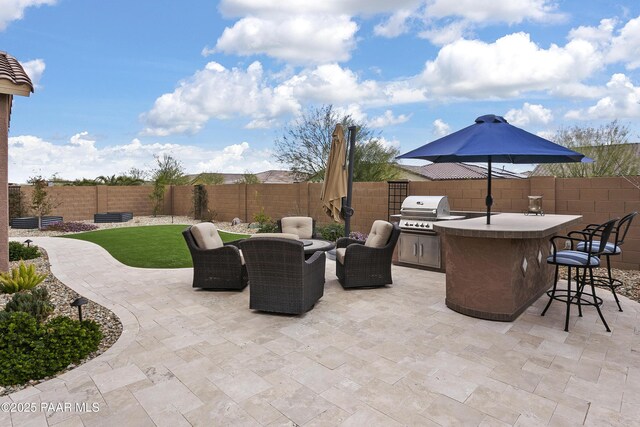 24757 N 175th Dr, Surprise, AZ 85387 - fenced backyard with a patio, an outdoor hangout area, and exterior kitchen