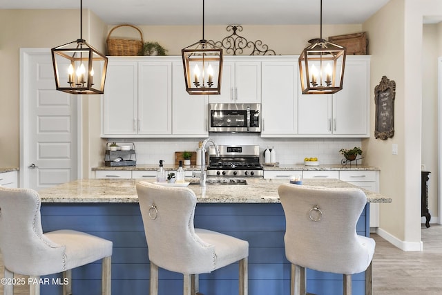 24757 N 175th Dr, Surprise, AZ 85387 - kitchen featuring a chandelier, backsplash, and appliances with stainless steel finishes