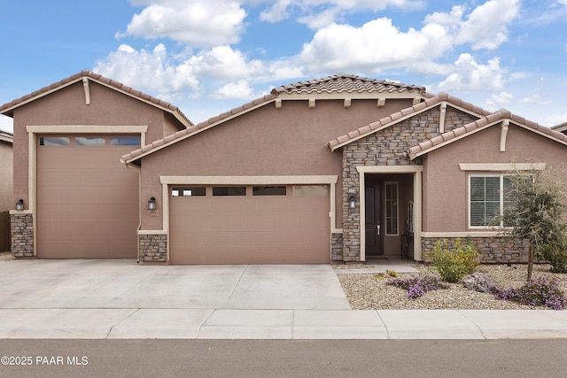 24757 N 175th Dr, Surprise, AZ 85387 - mediterranean / spanish home featuring a garage, stone siding, stucco siding, and concrete driveway
