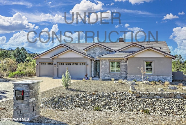 view of front of home featuring stone siding, a tiled roof, decorative driveway, an attached garage, and a chimney