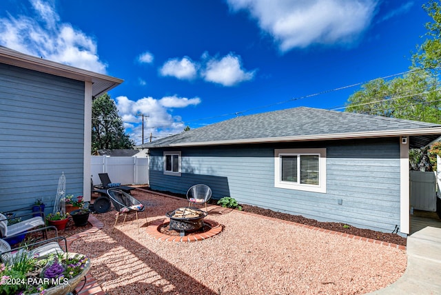 306 S Mt Vernon Ave, Prescott, AZ 86303 - rear view of house featuring a shingled roof, a patio area, fence, and a fire pit