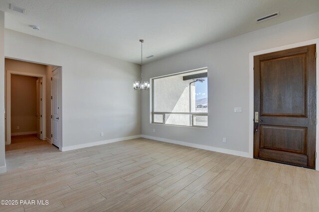 spare room featuring ceiling fan and light hardwood / wood-style floors