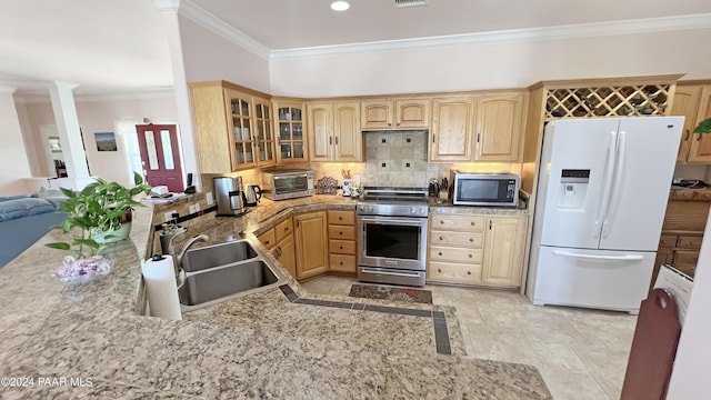 kitchen with decorative columns, tasteful backsplash, ornamental molding, stainless steel appliances, and sink