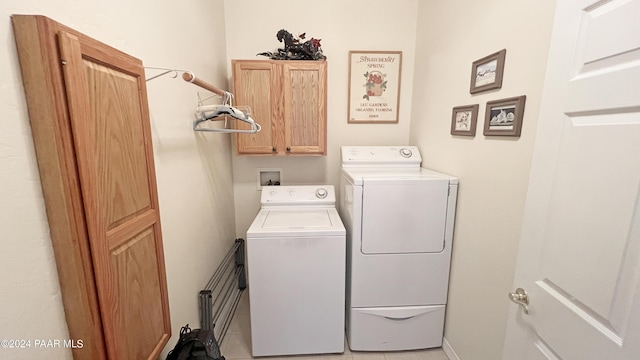 washroom with washer and clothes dryer, tile patterned flooring, and cabinets