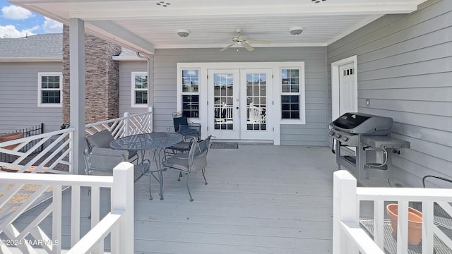 wooden deck with ceiling fan, a grill, and french doors