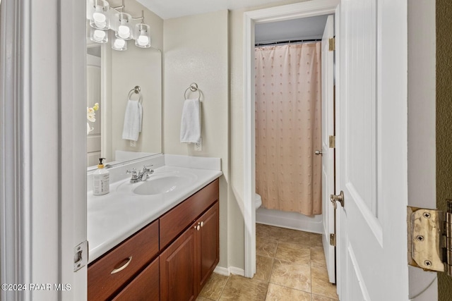 full bathroom with toilet, baseboards, and vanity