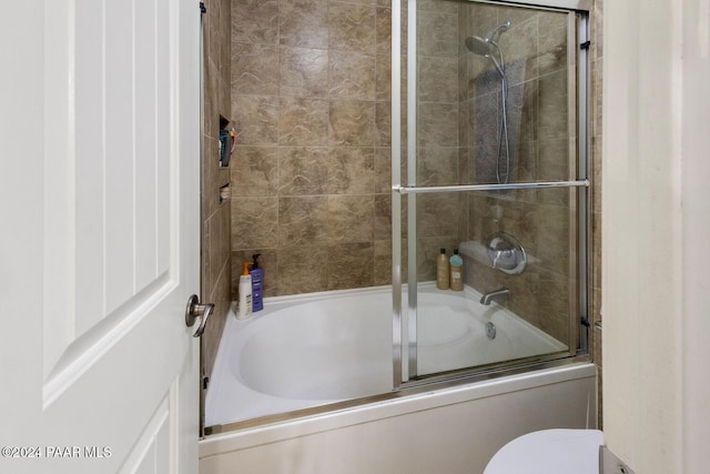 full bathroom featuring bath / shower combo with glass door and toilet