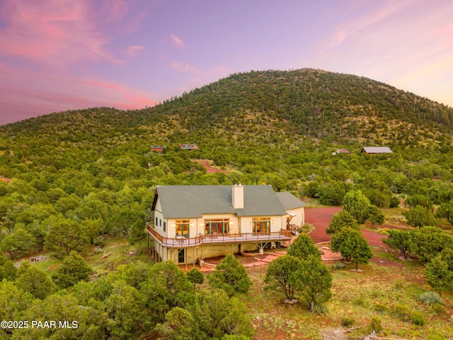 2667 N Overlook Dr, Williams, AZ 86046 - back of house with a deck with mountain view and a wooded view