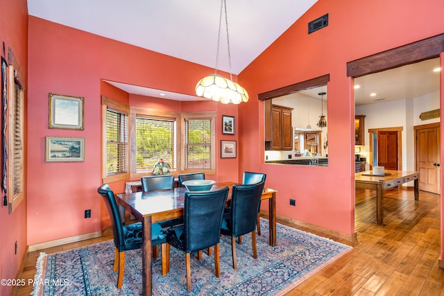 2667 N Overlook Dr, Williams, AZ 86046 - dining space featuring light wood-type flooring, baseboards, and high vaulted ceiling
