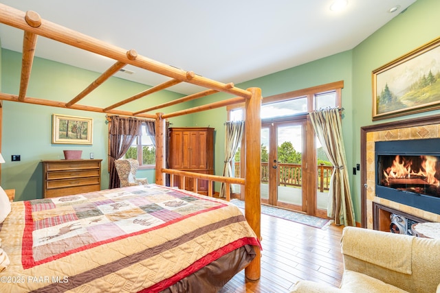 2667 N Overlook Dr, Williams, AZ 86046 - bedroom featuring access to outside, multiple windows, wood-type flooring, a tile fireplace, and recessed lighting