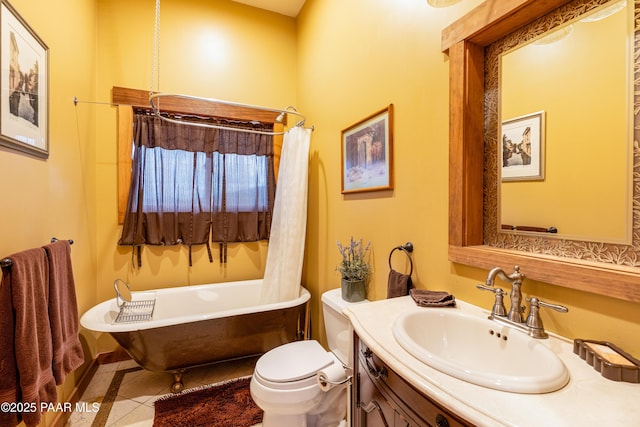 2667 N Overlook Dr, Williams, AZ 86046 - bathroom with a freestanding tub, vanity, tile patterned flooring, and toilet