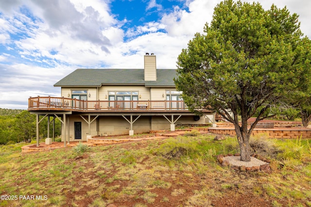 2667 N Overlook Dr, Williams, AZ 86046 - back of house featuring a deck, a chimney, and a shingled roof