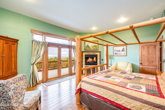 2667 N Overlook Dr, Williams, AZ 86046 - bedroom featuring access to outside, light wood-style floors, a tile fireplace, and recessed lighting