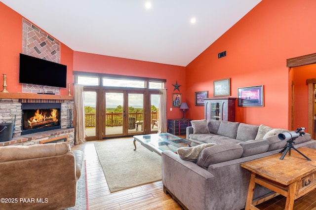2667 N Overlook Dr, Williams, AZ 86046 - living area with high vaulted ceiling, a large fireplace, light wood-style floors, and recessed lighting