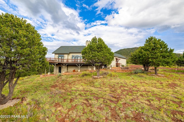 2667 N Overlook Dr, Williams, AZ 86046 - back of house featuring a deck and a chimney