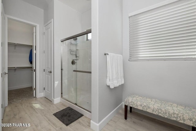 7942 E Carbon Ct Unit 20-A, Prescott Valley, AZ 86315 - bathroom with a shower stall, wood finished floors, and a walk in closet