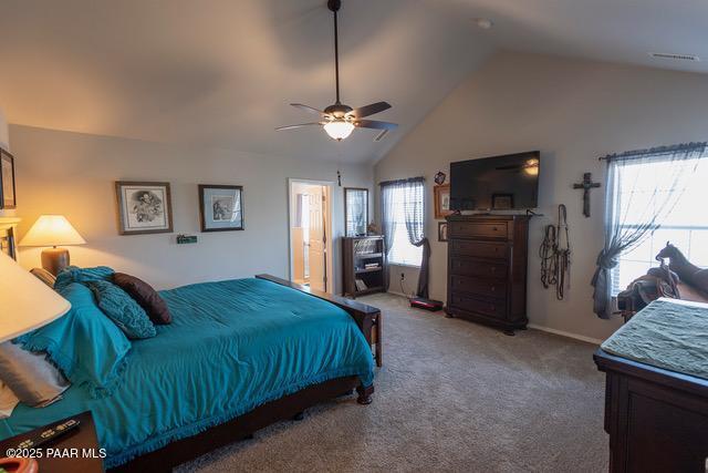 carpeted bedroom featuring ceiling fan and vaulted ceiling