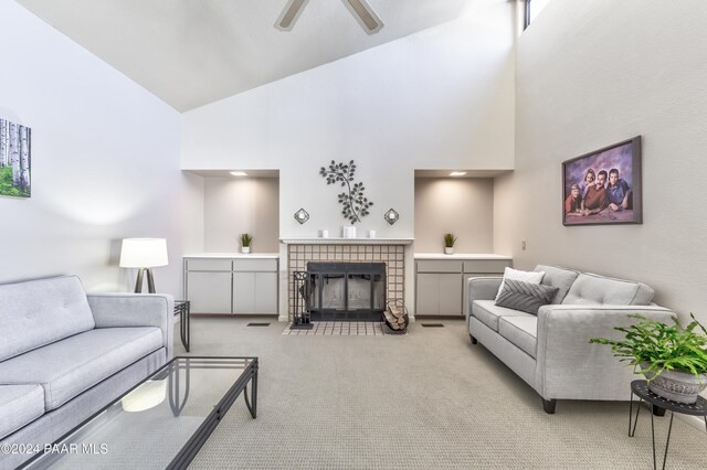 1665 Quail Run, Prescott, AZ 86303 - living room with a tile fireplace, light carpet, high vaulted ceiling, and ceiling fan