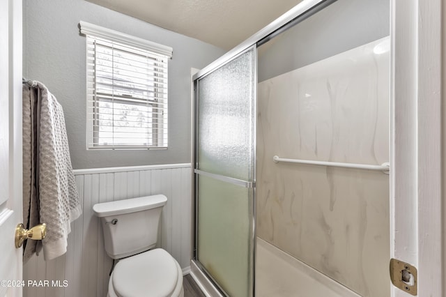 1665 Quail Run, Prescott, AZ 86303 - bathroom featuring toilet, a shower with door, and wooden walls