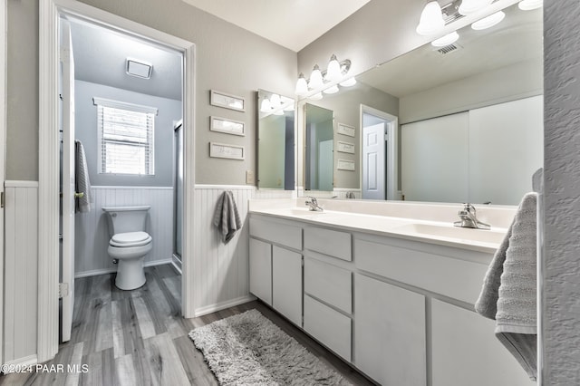 1665 Quail Run, Prescott, AZ 86303 - bathroom featuring hardwood / wood-style floors, vanity, toilet, and a shower with shower door
