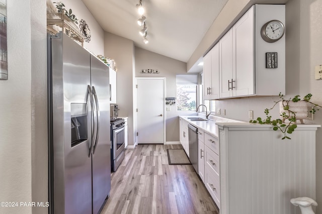 1665 Quail Run, Prescott, AZ 86303 - kitchen featuring stainless steel appliances, sink, light hardwood / wood-style floors, white cabinetry, and lofted ceiling