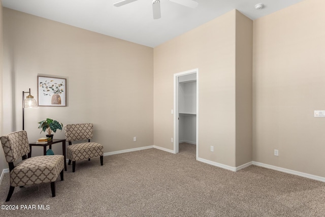 living area featuring carpet and ceiling fan