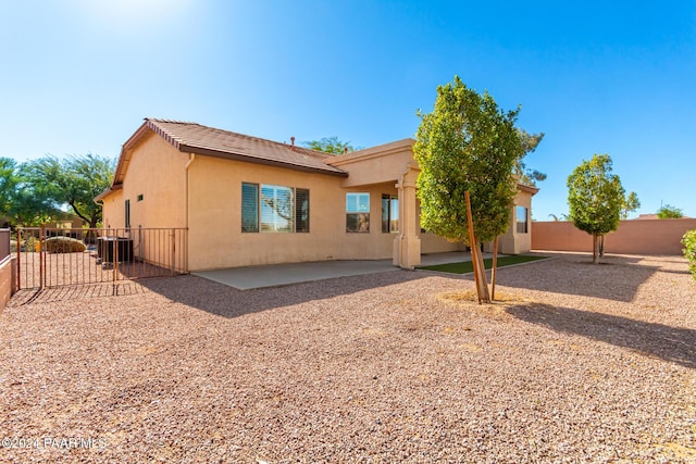 back of property featuring central air condition unit and a patio