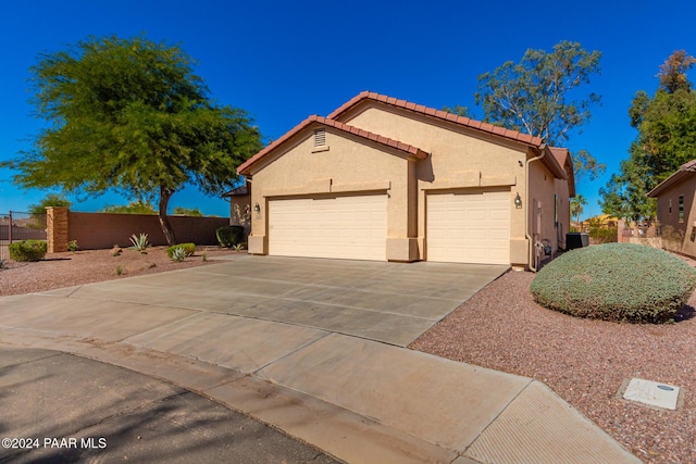 view of front of house with central AC and a garage