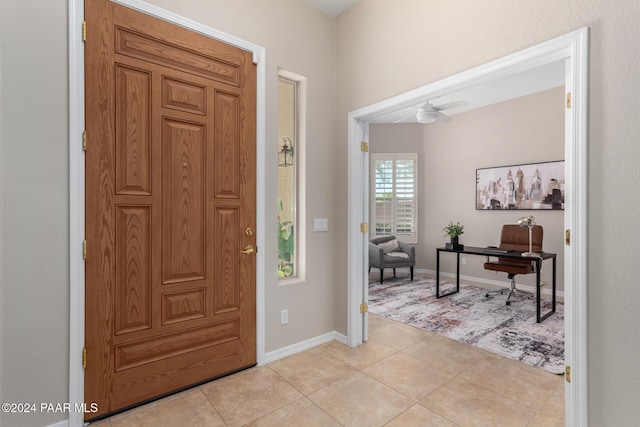 foyer with ceiling fan and light tile patterned flooring