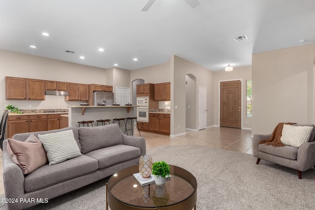 living room featuring ceiling fan and light tile patterned floors