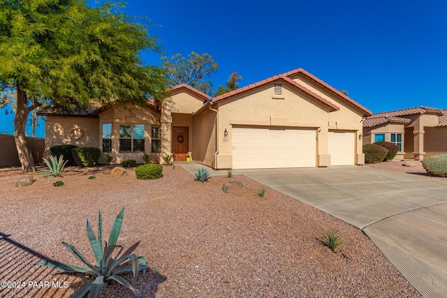 mediterranean / spanish-style home with a garage