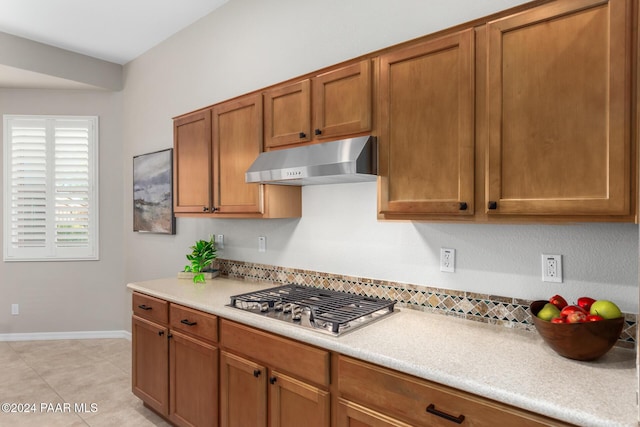 kitchen with stainless steel gas stovetop and light tile patterned floors