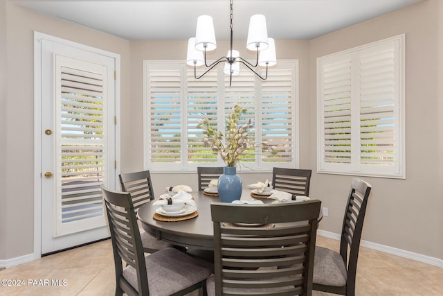 tiled dining space featuring a chandelier