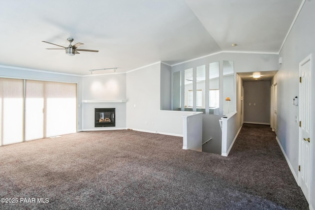 739 Yavapai Hills Dr, Prescott, AZ 86301 - unfurnished living room with ornamental molding, carpet, ceiling fan, vaulted ceiling, and a glass covered fireplace