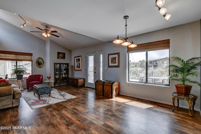 living area with visible vents, lofted ceiling, and wood finished floors