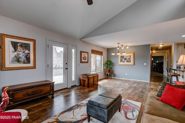 living room featuring baseboards, lofted ceiling, and wood finished floors