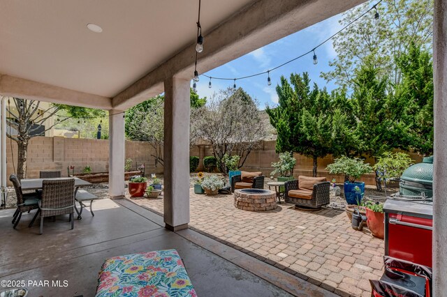 view of patio featuring a fire pit, a fenced backyard, and outdoor dining space
