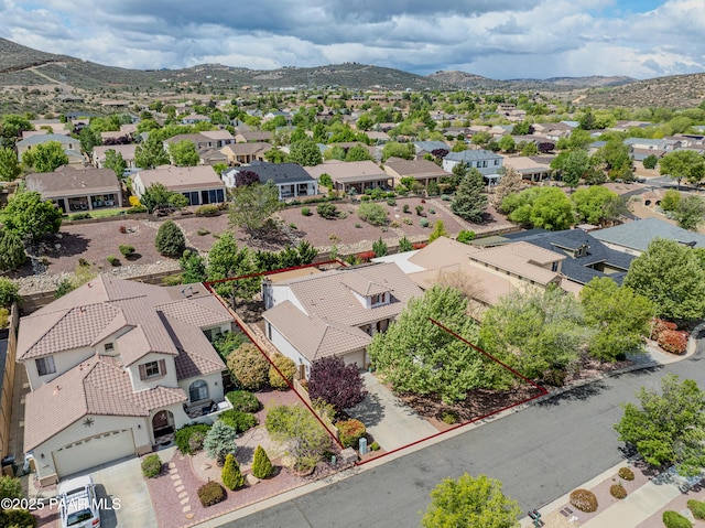 aerial perspective of suburban area featuring property boundaries highlighted and a mountain backdrop