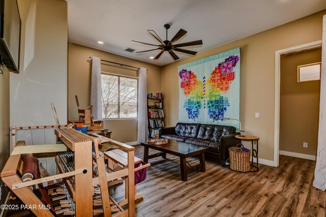 living area with ceiling fan, wood finished floors, baseboards, and recessed lighting