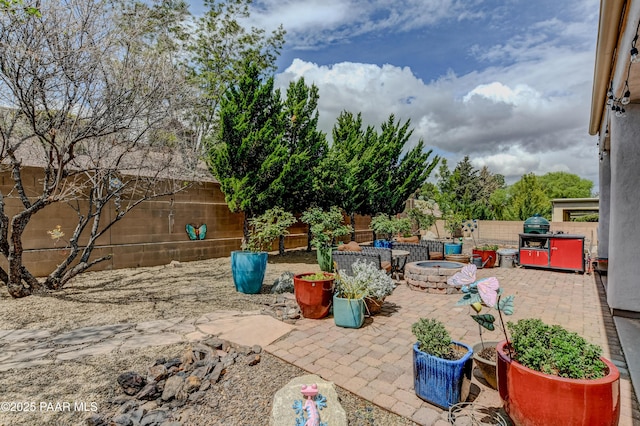 view of patio / terrace featuring a fire pit and a fenced backyard