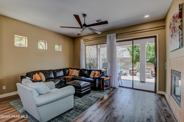 living area featuring healthy amount of natural light, wood finished floors, a ceiling fan, and recessed lighting