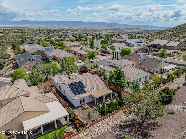 aerial perspective of suburban area with property parcel outlined and a mountain backdrop