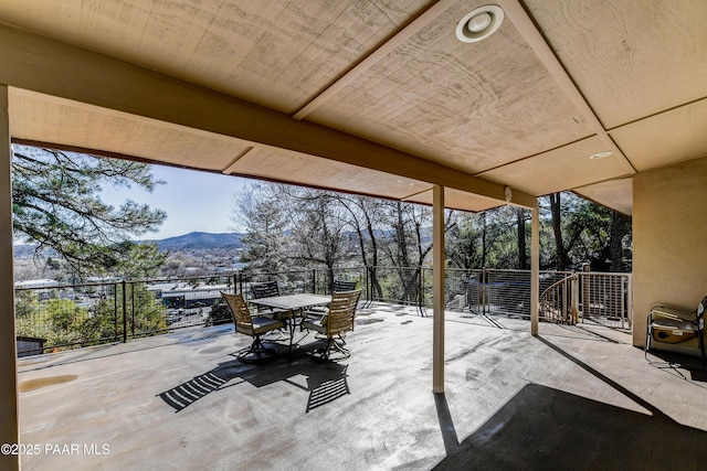 view of patio featuring outdoor dining area and a mountain view