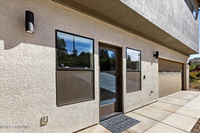 1841 N Jade Cir, Prescott, AZ 86301 - property entrance featuring stucco siding, driveway, and an attached garage