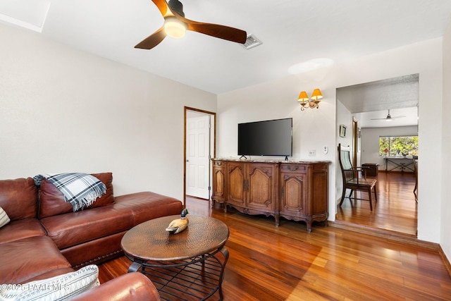 living room featuring visible vents, ceiling fan, and wood finished floors