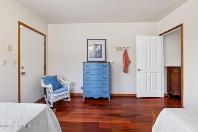 bedroom with baseboards and wood finished floors