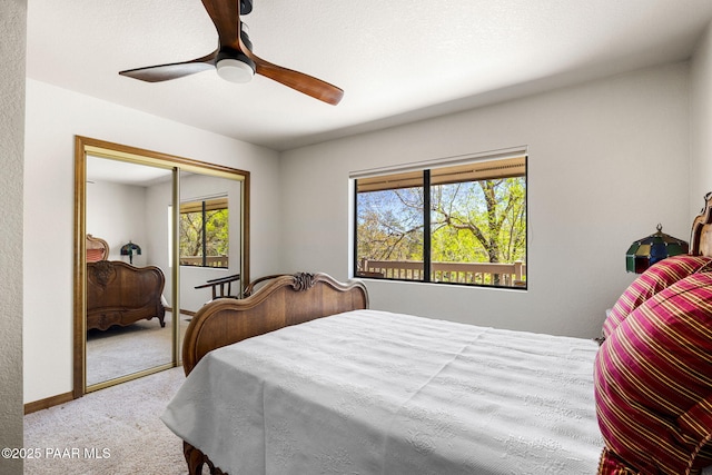 bedroom featuring a closet, carpet flooring, a ceiling fan, and multiple windows