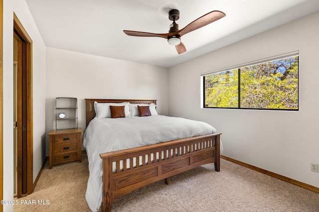 bedroom with baseboards, ceiling fan, and light colored carpet