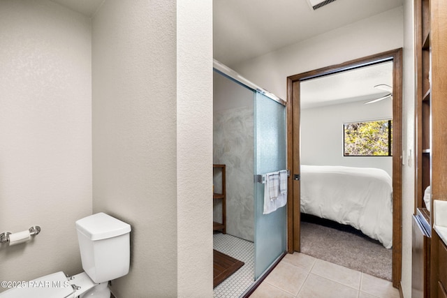 ensuite bathroom featuring toilet, ensuite bath, tile patterned flooring, and a stall shower